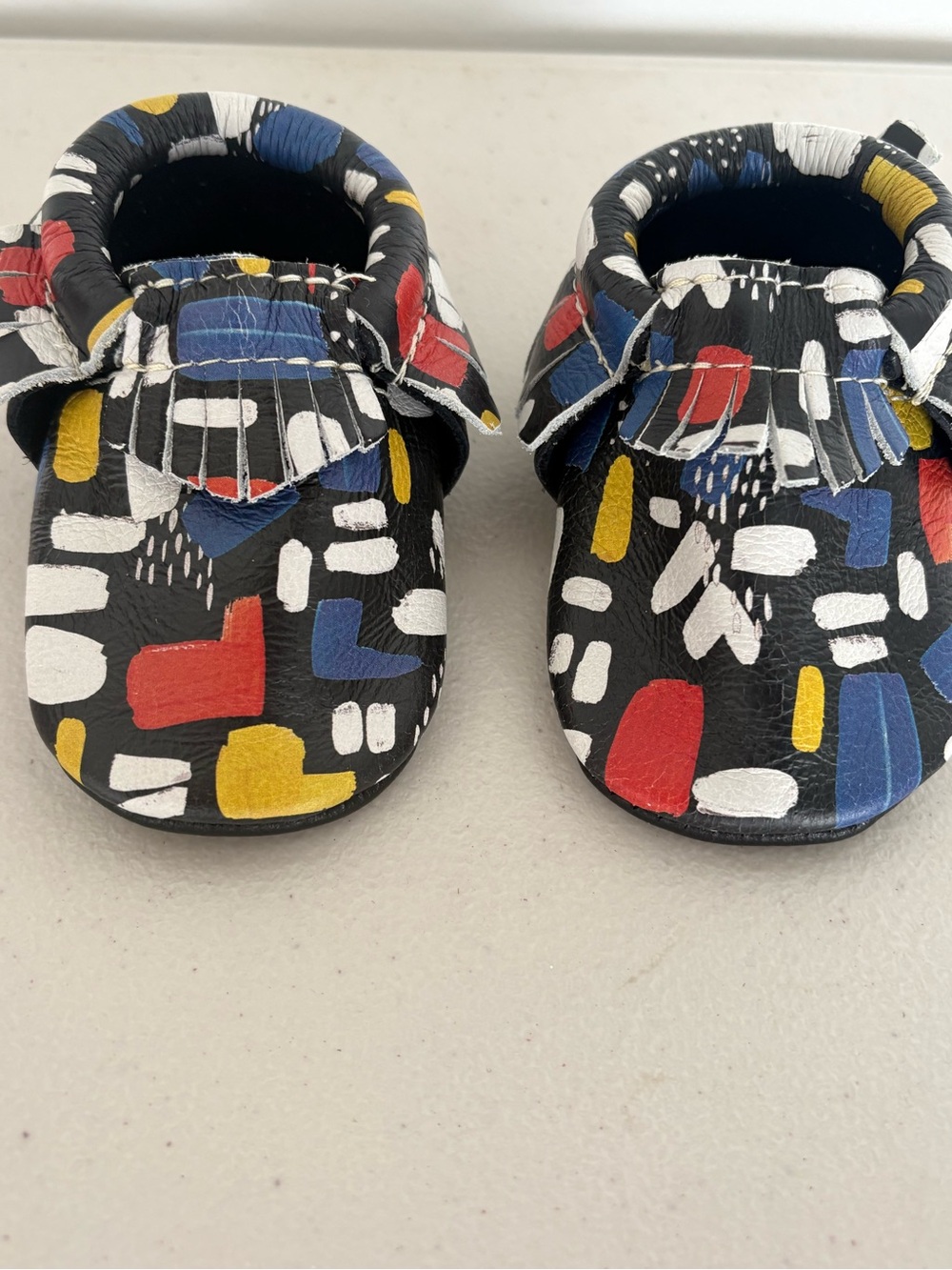 Freshly Picked Black Moccasins with Red, Blue & Yellow Abstract Print